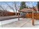 Backyard patio with pergola and wooden fence surrounds the property at 13586 W Warren Cir, Lakewood, CO 80228