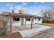 Backyard patio features a pergola, with access to the yard and house at 13586 W Warren Cir, Lakewood, CO 80228