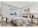 This bedroom features a comfortable bed and a bright window offering a view of the outdoors at 13586 W Warren Cir, Lakewood, CO 80228