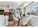 Bright dining area features a glass table, plush chairs, wood floors and stainless steel appliances at 13586 W Warren Cir, Lakewood, CO 80228