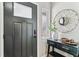 Modern entryway featuring a dark door with glass pane, decor, and console table at 13586 W Warren Cir, Lakewood, CO 80228