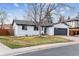 Charming one-story home with a well-maintained lawn and two car garage at 13586 W Warren Cir, Lakewood, CO 80228