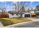 Beautiful home showcasing a well-manicured lawn and a convenient two-car garage at 13586 W Warren Cir, Lakewood, CO 80228