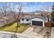 Aerial view of lovely home, showcasing landscaping, two car garage, and mountain view at 13586 W Warren Cir, Lakewood, CO 80228