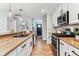 Bright kitchen with white cabinets, stainless steel appliances, and hardwood floors at 13586 W Warren Cir, Lakewood, CO 80228