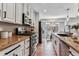 Well-lit kitchen featuring stainless steel appliances, hardwood floors, and neutral color scheme at 13586 W Warren Cir, Lakewood, CO 80228