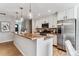 Lovely kitchen featuring a breakfast bar, stainless steel appliances, and hardwood floors at 13586 W Warren Cir, Lakewood, CO 80228