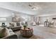 Cozy living room features neutral decor, large sofa, and round wicker coffee table at 13586 W Warren Cir, Lakewood, CO 80228