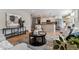 Inviting living room area featuring a view into the kitchen, and neutral toned furniture at 13586 W Warren Cir, Lakewood, CO 80228