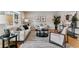 Comfortable living room featuring stylish decor, a patterned rug, neutral furniture, and bright, natural light at 13586 W Warren Cir, Lakewood, CO 80228