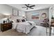 Comfortable main bedroom with a decorative ceiling fan, large bed, and ambient lighting at 13586 W Warren Cir, Lakewood, CO 80228