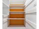 Well-organized storage shelves painted white with bright orange accents creating a functional space at 13586 W Warren Cir, Lakewood, CO 80228