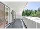 Long outdoor balcony overlooks lush green trees and blue skies at 1250 N Humboldt St # 202, Denver, CO 80218