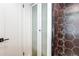 Bathroom featuring a tiled shower with a glass door and a separate linen closet at 1250 N Humboldt St # 202, Denver, CO 80218