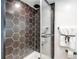 Bathroom boasts modern hexagon tile shower, glass doors, and black fixtures at 1250 N Humboldt St # 202, Denver, CO 80218