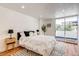 Bright bedroom with large bed, hardwood floors, and balcony access at 1250 N Humboldt St # 202, Denver, CO 80218