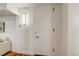 Clean hallway with neutral walls, stylish lighting, and white door at 1250 N Humboldt St # 202, Denver, CO 80218