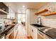 Updated kitchen with stainless steel appliances, granite countertops, and modern backsplash at 1250 N Humboldt St # 202, Denver, CO 80218