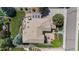 Aerial shot reveals backyard oasis complete with deck and brick patio set in verdant landscape at 9232 Rockport Ln, Highlands Ranch, CO 80126