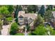 An aerial view of a two-story home with a well-maintained lawn and mature trees at 9232 Rockport Ln, Highlands Ranch, CO 80126