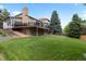 Expansive backyard featuring well-maintained lawn, mature trees and a spacious deck at 9232 Rockport Ln, Highlands Ranch, CO 80126