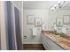 Bathroom with striped shower curtain, granite countertop, and framed prints at 9232 Rockport Ln, Highlands Ranch, CO 80126