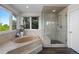Bright bathroom featuring a tub, glass shower, and large windows at 9232 Rockport Ln, Highlands Ranch, CO 80126