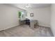 Neutral bedroom featuring a modern desk and a window overlooking greenery at 9232 Rockport Ln, Highlands Ranch, CO 80126