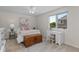 Bedroom with white ceiling fan, a side desk and a window overlooking greenery at 9232 Rockport Ln, Highlands Ranch, CO 80126