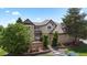 Charming two-story brick home with mature landscaping and inviting curb appeal at 9232 Rockport Ln, Highlands Ranch, CO 80126