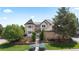 Charming two-story home with manicured lawn, mature trees, and brick accents at 9232 Rockport Ln, Highlands Ranch, CO 80126