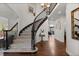 Elegant foyer with curved staircase, hardwood floors, and decorative lighting at 9232 Rockport Ln, Highlands Ranch, CO 80126