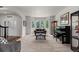 Bright living room features a bay window, piano, and neutral carpet flooring at 9232 Rockport Ln, Highlands Ranch, CO 80126