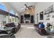 Spacious living room featuring a brick fireplace, high ceilings, and abundant natural light at 9232 Rockport Ln, Highlands Ranch, CO 80126