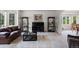 A cozy living room with bay windows, plush carpeting, and a decorative bookshelf at 9232 Rockport Ln, Highlands Ranch, CO 80126