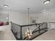 Open loft area with decorative chandelier and staircase at 9232 Rockport Ln, Highlands Ranch, CO 80126