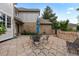 Charming brick patio features elegant brickwork, fountain and outdoor seating, perfect for entertaining at 9232 Rockport Ln, Highlands Ranch, CO 80126