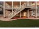 A spacious backyard with a patio, stairs to the deck, and artificial grass is perfect for entertaining at 10100 Isle St, Parker, CO 80134