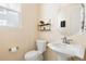 Cozy powder room featuring a pedestal sink, round mirror, and stylish decorations at 10100 Isle St, Parker, CO 80134