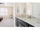 Elegant bathroom vanity featuring granite countertops and mirror in a well-lit space connecting to a play area at 10100 Isle St, Parker, CO 80134