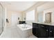 Elegant bathroom featuring a soaking tub, walk-in shower, and dual vanities at 10100 Isle St, Parker, CO 80134