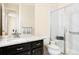 Well-lit bathroom featuring a glass shower, granite countertops, and a modern vanity at 10100 Isle St, Parker, CO 80134
