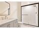 Bright bathroom featuring a tiled shower, modern vanity, and sleek fixtures, perfect for a relaxing experience at 10100 Isle St, Parker, CO 80134