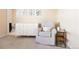 Charming Bedroom featuring a comfortable glider, stylish dresser, and adorable animal-themed wall art at 10100 Isle St, Parker, CO 80134