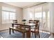 Open dining area with a large window and sliding door, seating for six, and stylish rug at 10100 Isle St, Parker, CO 80134
