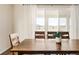 Comfortable dining area with ample natural light from a large window and glass sliding door at 10100 Isle St, Parker, CO 80134