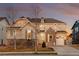 Charming two-story home featuring stone accents, a well-kept lawn, and attached garage at 10100 Isle St, Parker, CO 80134