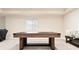 Game room features a versatile multi-game table, soft carpeting, and a comfortable bench with decorative pillows at 10100 Isle St, Parker, CO 80134