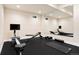 Home gym featuring a rower, weight bench, dumbbells, and a large mirror reflecting the workout space at 10100 Isle St, Parker, CO 80134