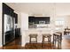 Modern kitchen with stainless steel appliances, granite countertops, and a breakfast bar at 10100 Isle St, Parker, CO 80134